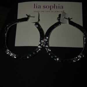 Silver stamped hoops with a wave to them.